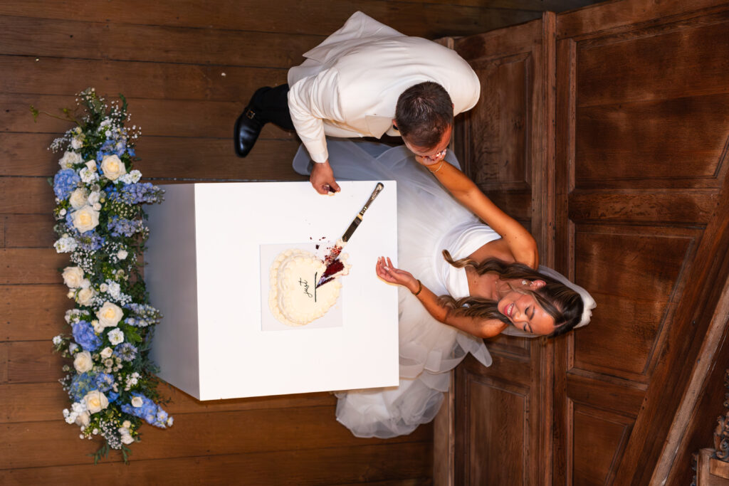 bride feeding groom wedding cake