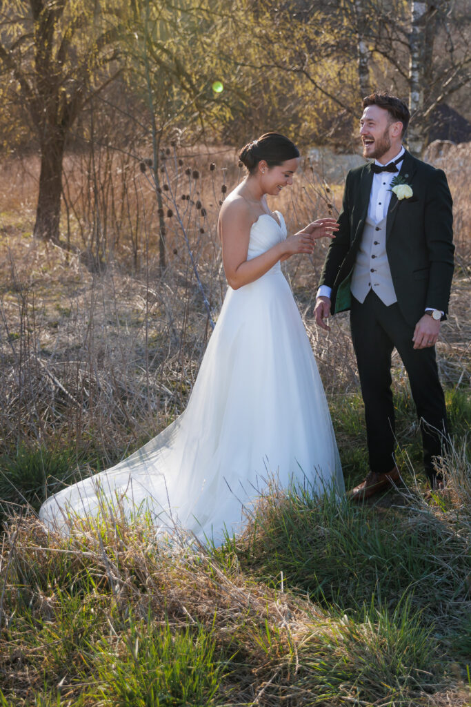 bride and groom laughing after a quiet moment
