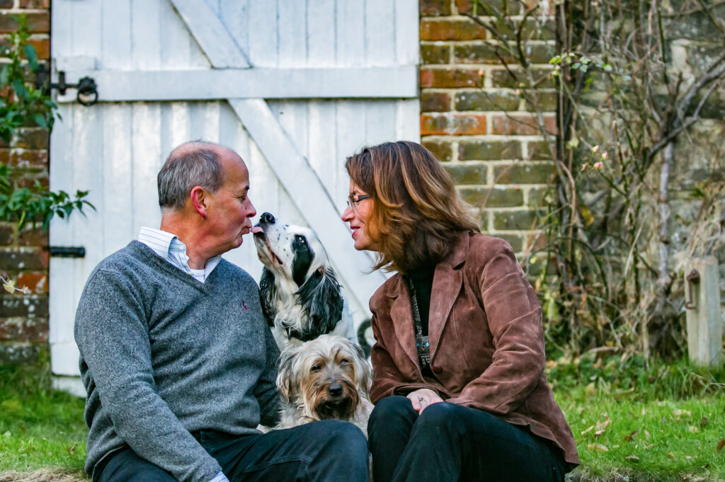 engaged couple sitting with their dogs