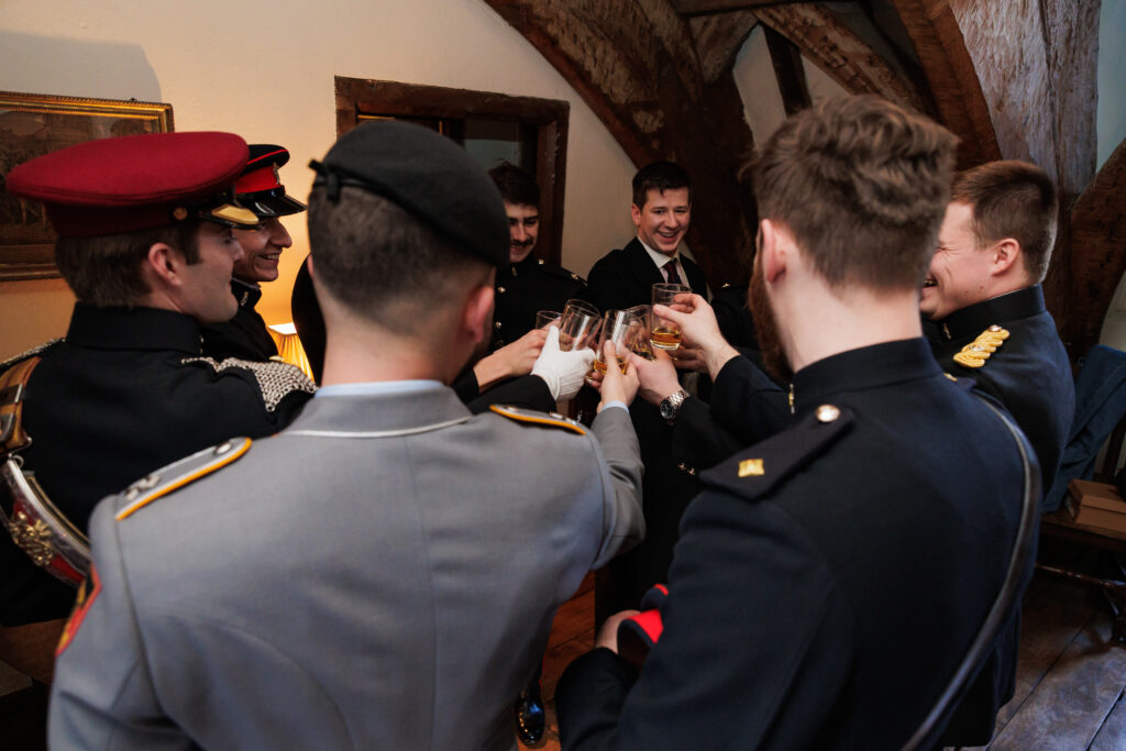 Groom, best man and groomsmen having a final toast before he gets married