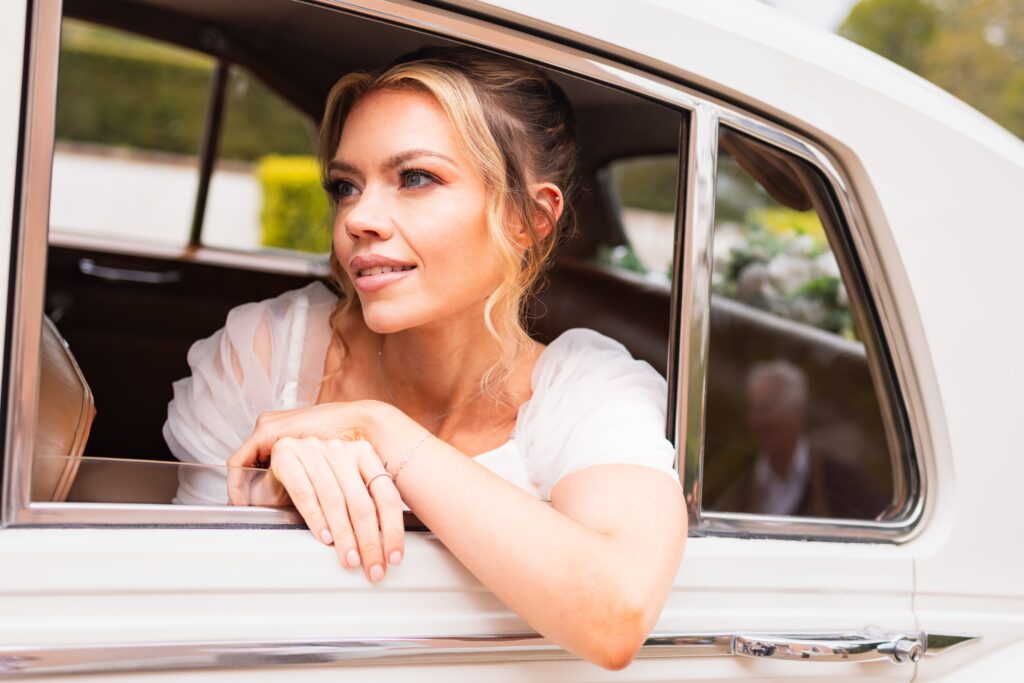 bride gazing out of her wedding car